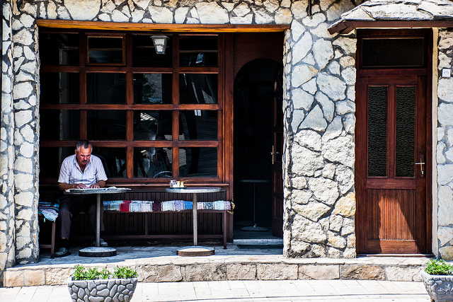 A man reading the papers in Konjic, Bosnia, while waiting for his morning coffee