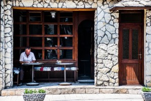 A man reading the papers in Konjic, Bosnia, while waiting for his morning coffee