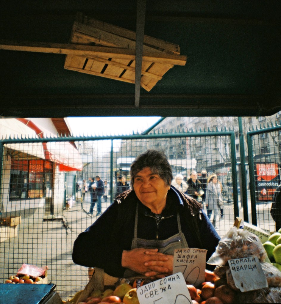 A woman selling apples at Bajloni green market in Belgrade