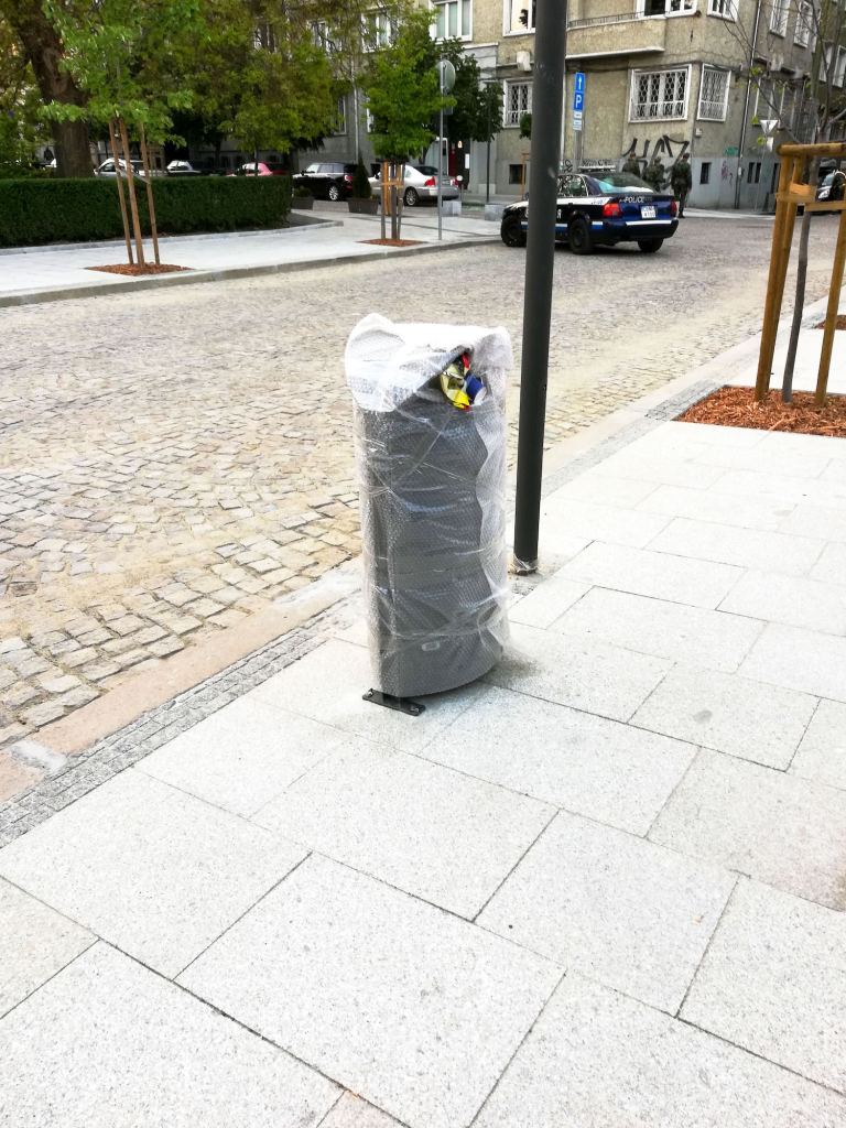 A public bin fully protected by plastic