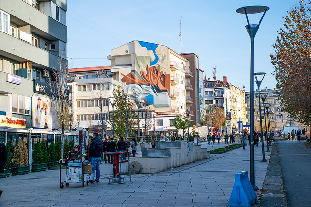 A street in the centre of Pristina in Kosovo with a beautiful street art piece on a wall
